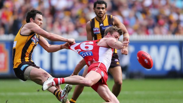 All caught up: Luke Parker is tackled by Jordan Lewis in the 2014 grand final.