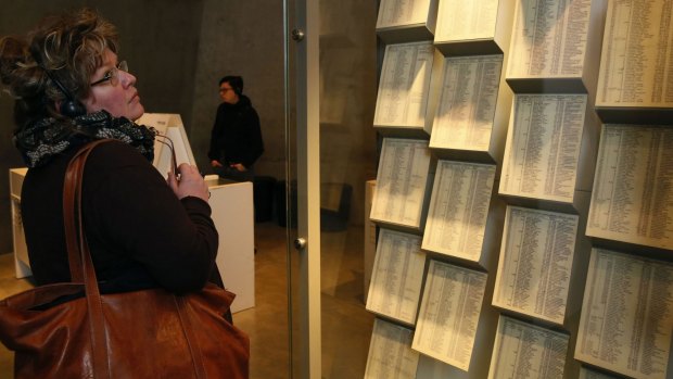 A woman looks at facsimiles of Oskar Schindler's lists displayed for the public at the Yad Vashem Holocaust memorial museum in Jerusalem.