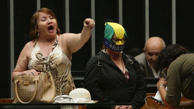 A woman shouts slogans as a group of people calling for a military coup walk into the floor of Congress in Brasilia on Wednesday.