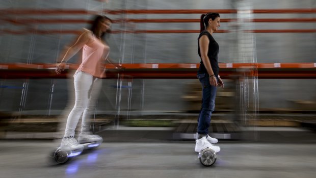 Paulina Ciurzynska and Laeyna Rillotta hoverboard their way around the Future Wheels warehouse in Bayswater. 