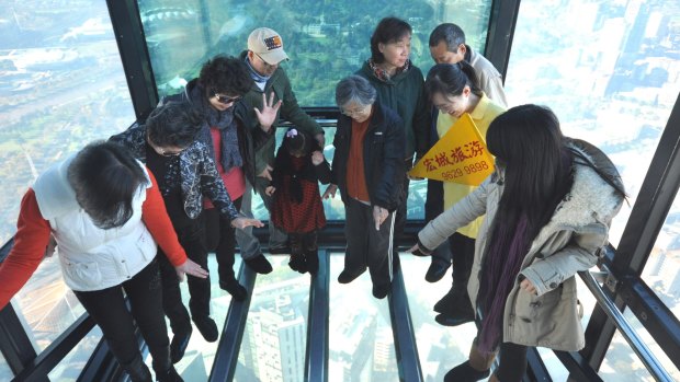 A tour group visiting Eureka Skydeck's The Edge in Melbourne. The bottom has fallen out of the Chinese tourist market for Australia. 