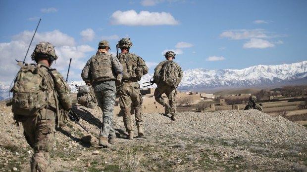 US soldiers patrol into a village near Pul-i-Alam, Afghanistan, in March 2014.