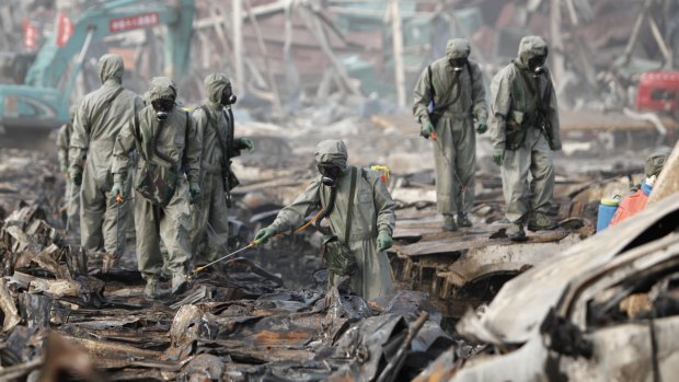 Rescuers spray hydrogen peroxide at the site of Tianjin warehouse explosion.