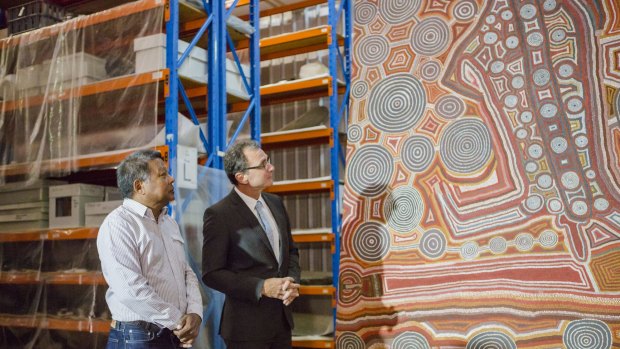 National Museum council member, and Indigenous advisory committee chairman, Peter Yu and National Museum director Mathew Trinca with 'Yumari' by Uta Uta Tjangala. The canvas will be sent to London for an exhibition at the British Museum in April. 