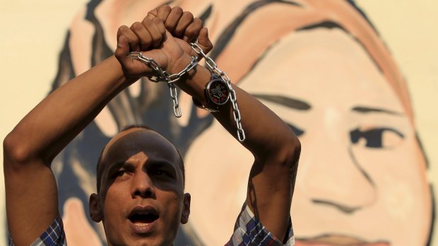 An Egyptian holds up chains as a protest against the detention of journalists in front of the Press Syndicate in Cairo.