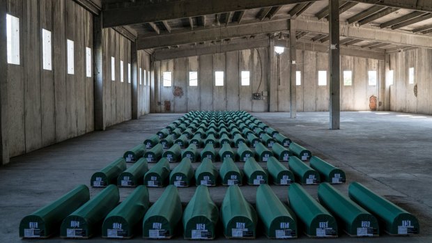 Coffins of 127 victims of the Srebrenica massacre sit in a former battery factory in Potocari, before they were taken to be buried at a nearby memorial center, in Bosnia, in July.