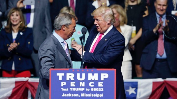 Donald Trump welcomes Nigel Farage to the stage.