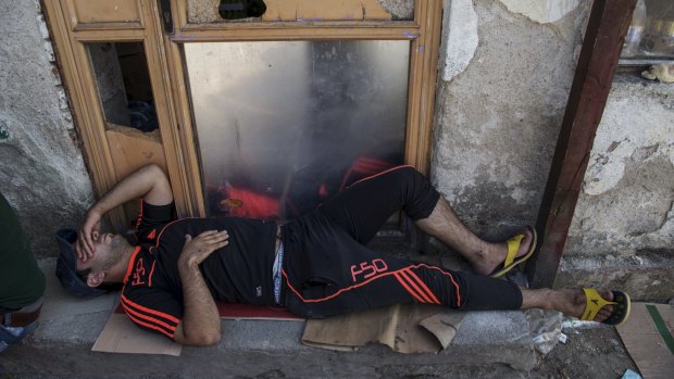 A migrant alseep on a street in the town of Presevo, Serbia, on Monday.