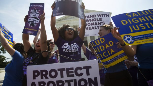 Pro-choice activists celebrate at the Supreme Court on Monday.