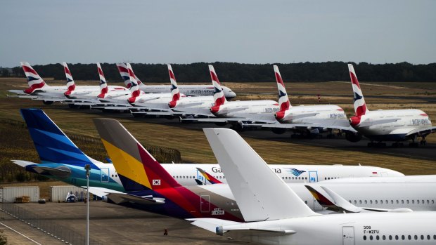 A fleet of Airbus SE A380 passenger aircraft, operated by British Airways, sit parked near other grounded jets at Chateauroux airport in France.