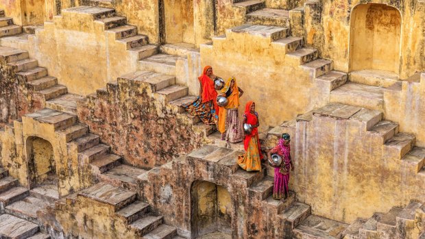 Women gathering water from a stepwell in Amer, near Jaipur,