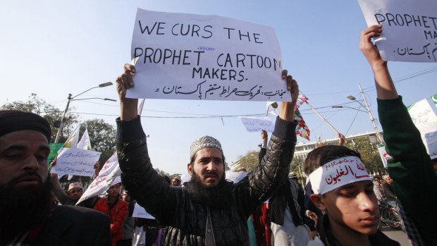 People chant slogans during a protest against Charlie Hebdo in Lahore on Thursday.