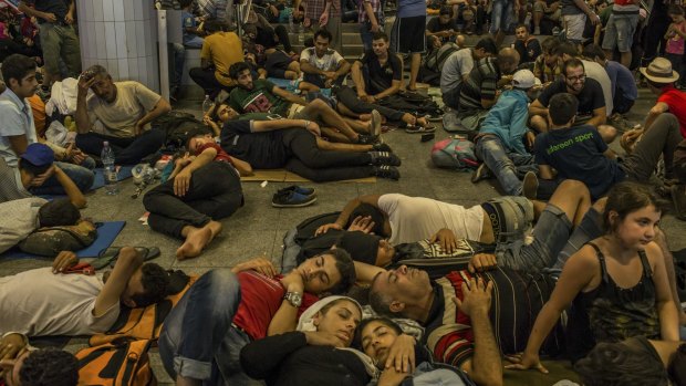 Families sleep underneath the Keleti train station in Budapest.