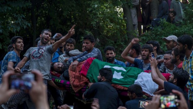 Kashmiri villagers shout freedom slogans as they display the body of rebel leader Sabzar Ahmed Bhat in Tral, 45 kilometres south of Srinagar.