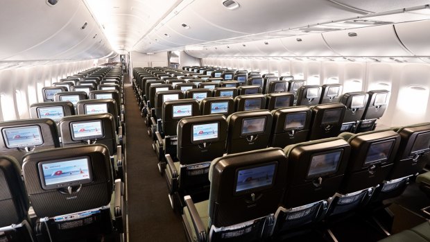 The rear of an economy cabin on board a Qantas 747 jumbo jet where the configuration changes to 2-4-2.