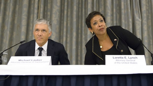Swiss attorney-general Michael Lauber and his US counterpart, Loretta Lynch, speak to the media in Zurich on Monday.