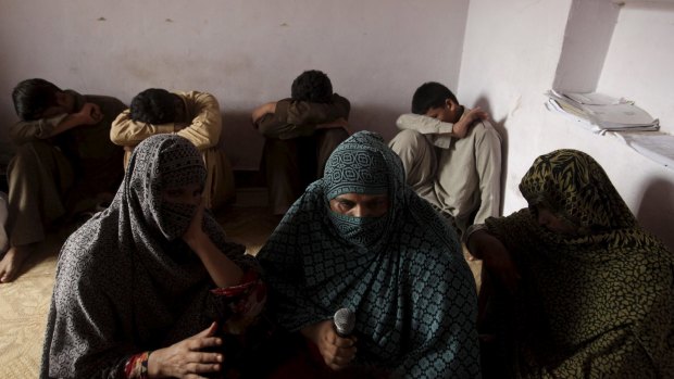 Young boys who have been sexually abused, according to their families, hide their faces while their mothers are interviewed by a Reuters correspondent in the village of Husain Khan Wala, Punjab province, Pakistan.