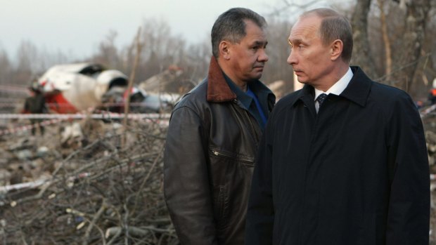 The then Russian prime minister Vladimir Putin, right, and Emergency Situations Minister Sergei Shoigu, left, visit the crash site of the Polish presidential plane near Smolensk on April 10, 2010.