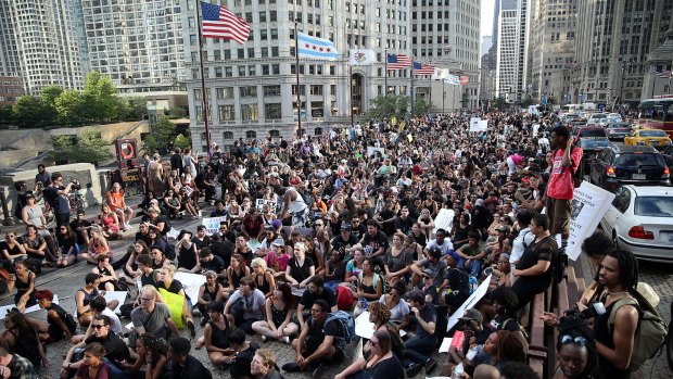 Activists rally against police brutality in downtown Chicago on Monday.