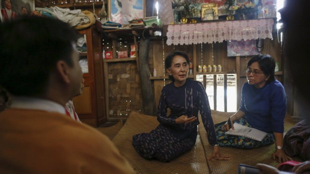 Myanmar pro-democracy leader Aung San Suu Kyi goes visiting constituents in Warheinkha village during her voter education campaign.