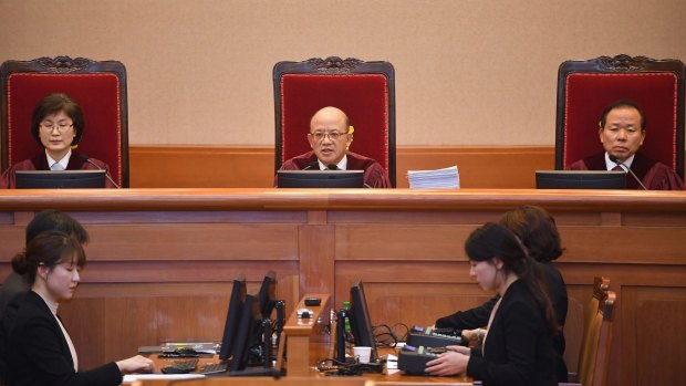 Chief Justice Park Han-Chul, centre, presides over the first hearing arguments for South Korean President Park Geun-hye's impeachment trial on Tuesday.