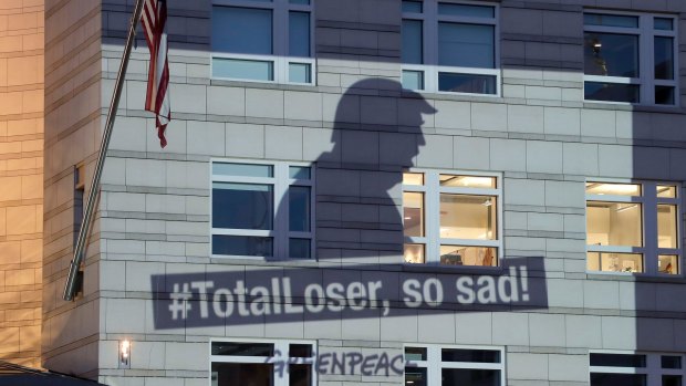 A Greenpeace banner showing US President Donald Trump is projected onto the facade of the US Embassy in Berlin, on Friday.