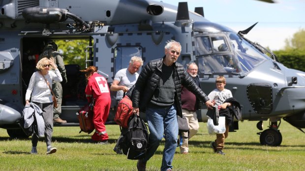 Tourists trapped by the Kaikoura earthquakes arrive by military helicopters at Woodend School grounds in Christchurch on Tuesday.