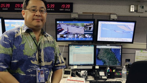 Jeffrey Wong, the Hawaii Emergency Management Agency's current operations officer, shows computer screens monitoring hazards at the agency's headquarters in Honolulu on Friday.