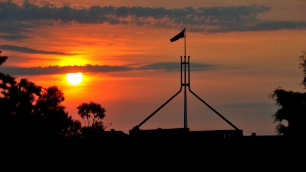 Boom or bust: The sun sets over Parliament House, Canberra. 