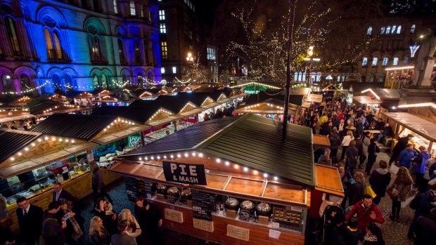 Manchester's Christmas Market with food stalls, bars, Christmas decorations and gift stalls.