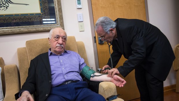 Fethullah Gulen, whom the Turkish government accuses of masterminding last year's coup, has his blood pressure checked at his compound in Saylorsburg,  Pennsylvania.