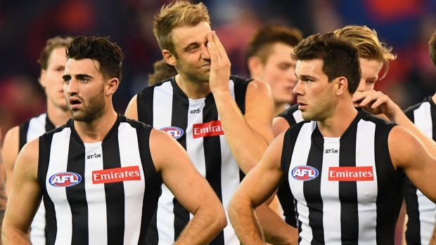 Down in the mouth: Dejected Magpies after Collingwood’s loss to Melbourne last Sunday. 