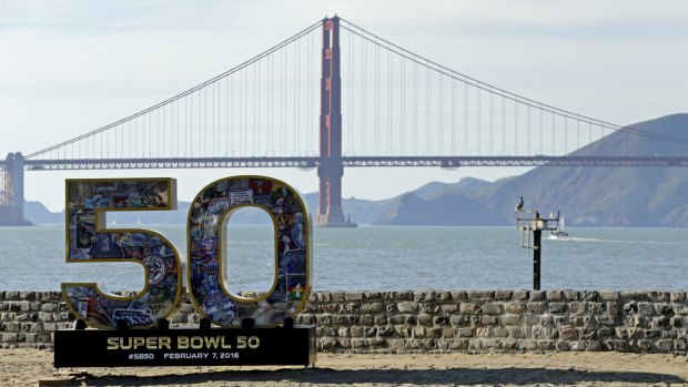 A Super Bowl 50 sign rests on the beach near the Golden Gate Bridge in San Francisco. Seven teenagers were rescued from forced prostitution during the event.