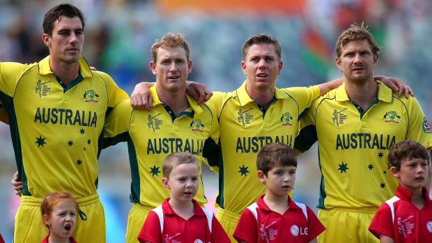 Unusual position: Shane Watson (right) and fellow unused squad members Pat Cummins, George Bailey and Xavier Doherty sing the national anthem before the World Cup match against Afghanistan.