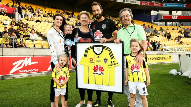 Phoenix skipper Andrew Durante poses with his parents and family after being presented a shirt to mark his 200th game.