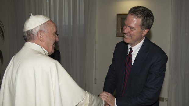 Pope Francis shakes hands with new spokesman Greg Burke at the Vatican on Monday.
