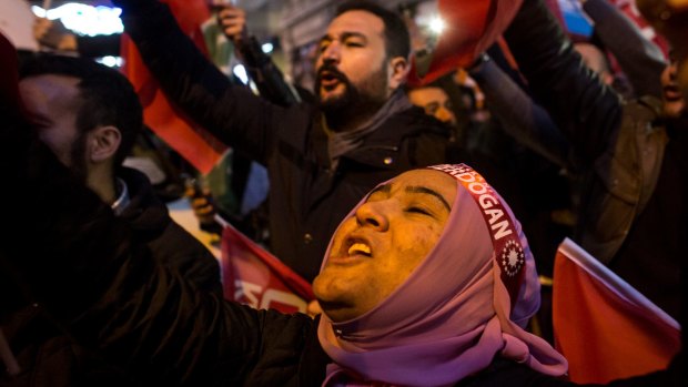 Protesters sing and chant outside the Dutch consulate in Istanbul after Turkey's foreign minister was turned away from the Netherlands.
