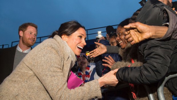 Prince Harry, left, and his fiancee Meghan Markle meet members of the public following a visit to the Reprezent FM in Brixton, south London, on January 9.
