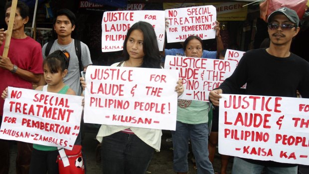 Supporters of slain transgender Filipino Jeffrey "Jennifer" Laude, hold placards during a rally outside a courthouse in Olongapo city on Monday. 