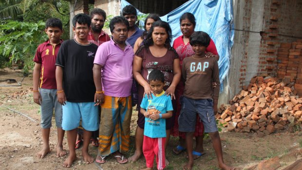 Mr Kuruppu (in purple shirt) with his family and the families of Janaka Athukorala (in background with beard) and Sujeewa Saparamadu (second from right).