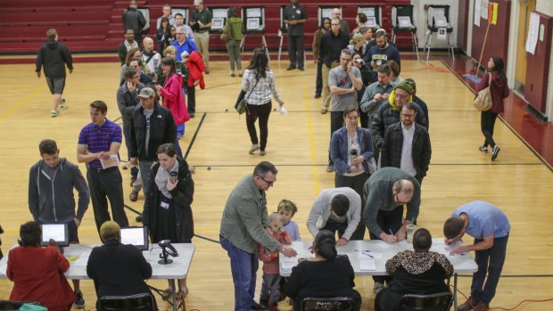 Voters line up to vote during the primary election at Henry W. Grady High School on Tuesday.