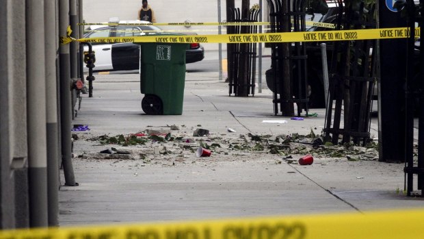 Debris is seen on the sidewalk below the balcony which collapsed. 