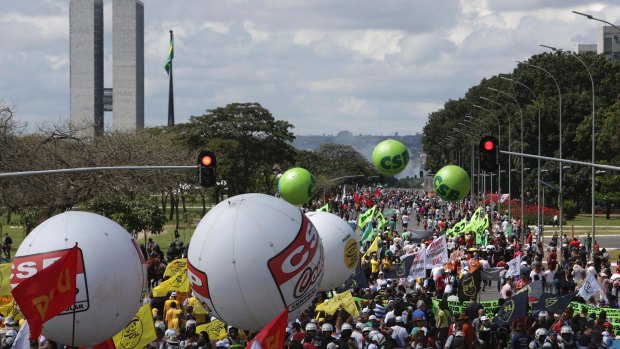 Demonstrators march during a general strike in Brasilia, on Friday.