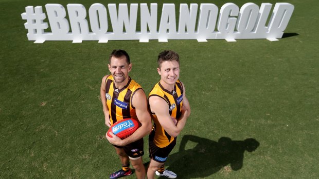 Hawthorn captain Luke Hodge and Liam Shiels in front of a promotional sign that supporters can take photos with before Monday’s Hawthorn-Geelong game at the MCG. 