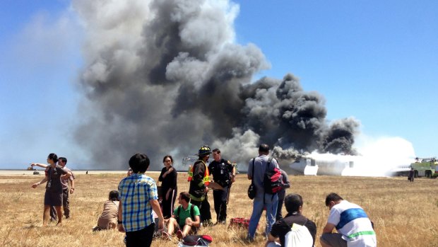 Passengers from Asiana Airlines flight 214, many with their luggage, on the tarmac just moments after the plane crashed at the San Francisco International Airport in San Francisco. 