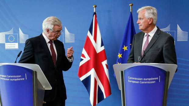 David Davis, Secretary for the UK exiting the EU, left, gestures while speaking as Michel Barnier, chief negotiator for the EU, listens in Brussels.