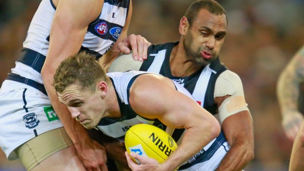 Travis Varcoe tries to get hold of Joel Selwood of the Cats in round six when Geelong inflicted a big defeat on the Pies.