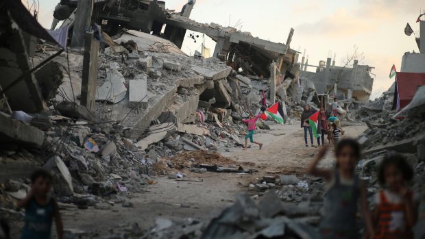 In September last year, Palestinian children play near the ruins of their houses  in the devastated area of the east of Gaza City, destroyed during the seven-week Israeli offensive last year.