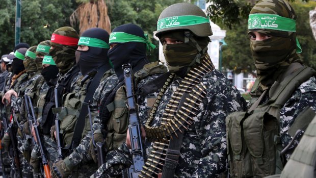 Masked militants from the Izzedine al-Qassam Brigades, a military wing of Hamas, attend the mourning ceremony for Mohammed al-Zoari, a Tunisian aviation engineer shot dead in Tunisia last year.
