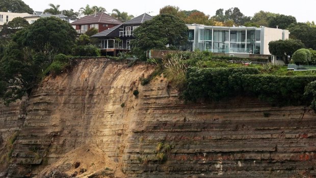 Homes on the edge of the cliff in Browns Bay, Auckland, face evacuation after overnight slips sent part of their garden into the sea.